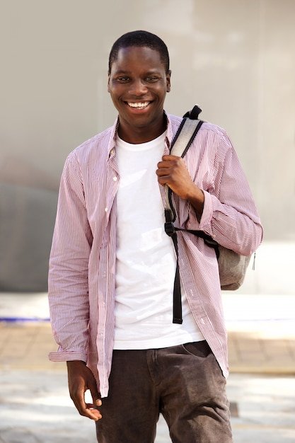 handsome-young-african-student-smiling-outdoors-with-bag_33839-11829